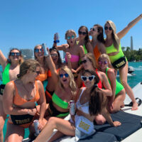 A Bachelorette party posing for a picture while our Miami boat charter cruises near monument island.